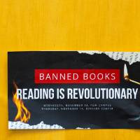 paper taped to a door that reads "Banned books: reading is revolutionary"